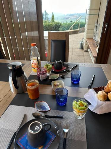 a table with plates of food on a table at LES JARDINS DE CARIBOLE in Fourneaux
