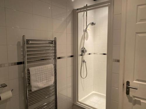 a bathroom with a shower with a glass door at Contractors Home - 4 Bedroom Long Stays Welcome - Barnsley in Shafton