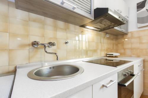 a bathroom with a sink and aaucet at Apartment Neven in Rogoznica
