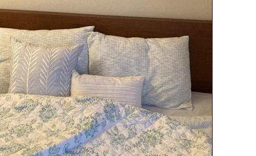 a bed with blue and white sheets and pillows at Home sweet home in Hillsboro