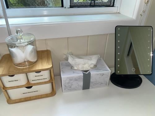 a counter with boxes and a window and a mirror at Hideaway on Hume #2 in Boonah