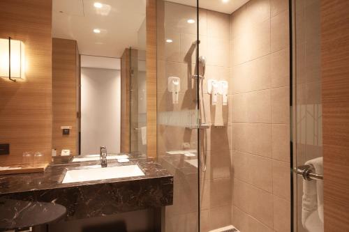a bathroom with a sink and a shower at Crown Park Hotel Seoul Myeongdong in Seoul