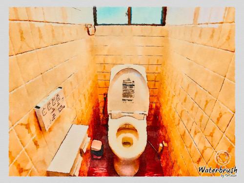 an overhead view of a toilet in a stall at Guest House Nagasaki 2 御船蔵の我が家 2 in Nagasaki