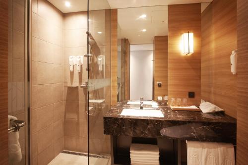 a bathroom with a sink and a shower at Crown Park Hotel Seoul Myeongdong in Seoul