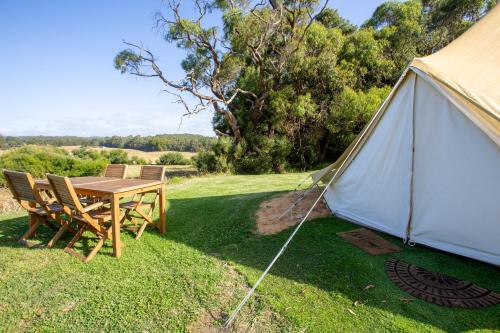 a tent with a table and chairs in the grass at Forrest Holiday Park in Forrest