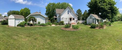 a house with a yard with green grass at Cozy Algoma Retreat! Minutes to Beach and Downtown! in Algoma