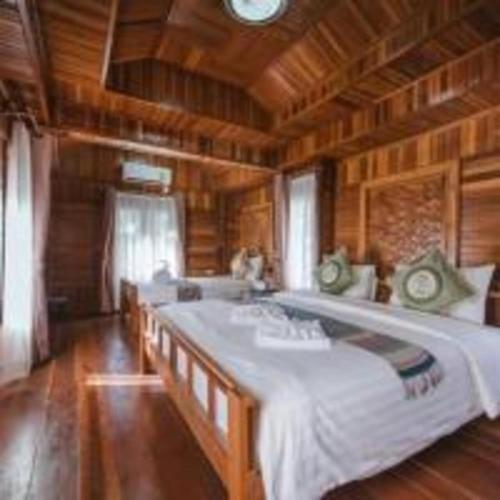 a bedroom with two large beds in a room at Park & Pool Resort in Nong Khai