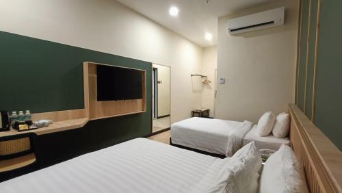 Ένα ή περισσότερα κρεβάτια σε δωμάτιο στο Urban Inn, Alor Setar