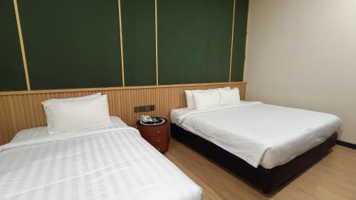 Ένα ή περισσότερα κρεβάτια σε δωμάτιο στο Urban Inn, Alor Setar