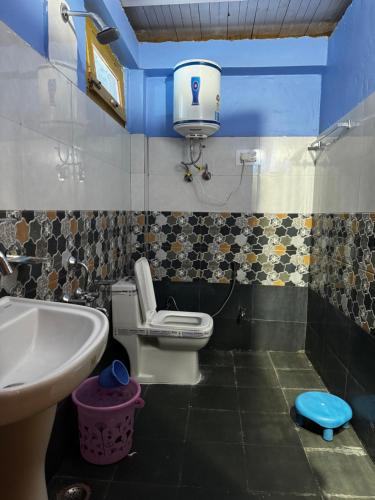 a bathroom with a toilet and a sink at Cafekush tosh in Tosh