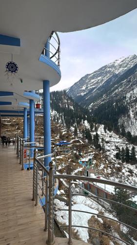 a ski lodge with a view of a snowy mountain at Cafekush tosh in Tosh