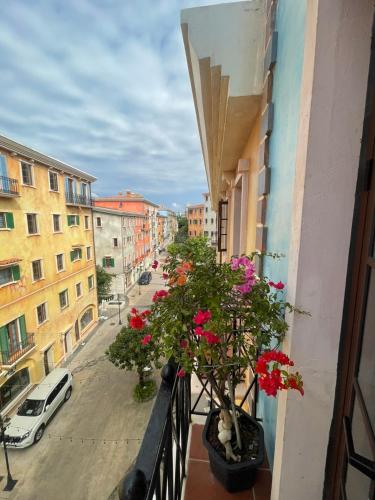 a balcony with flowers on a city street at Aurora Phu Quoc Hotel & Golf 3D in Phu Quoc