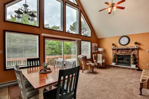 a dining room with a table and a fireplace at Chalet with Hot Tub near Lake, Pool and Beach in Albrightsville