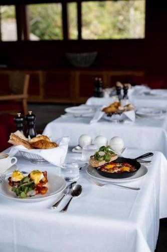 a white table with plates of food on it at La Reserve 1785 Canggu Beach - Adults Only in Canggu