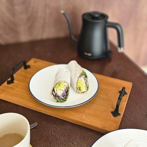 a plate of food on a table with a cup of coffee at Soban Stay in Busan