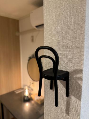a black chair sitting on a counter in front of a mirror at HAKUBA76 in Hakuba