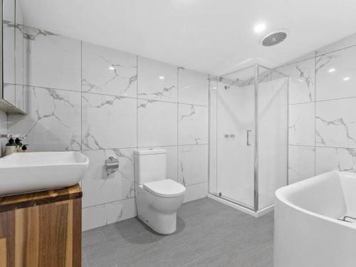 a bathroom with a toilet and a sink and a shower at NEW! Stunning 4BR Cottage In The Heart Of Ballarat - PET FRIENDLY & FAST WIFI in Ballarat