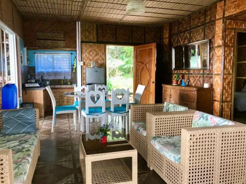 a living room with a couch and a table with chairs at Camotes Cay Hideaway in San Francisco