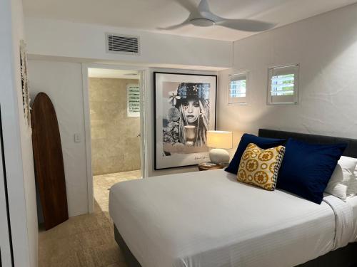 a bedroom with a large bed and a bathroom at Carramah Noosa Heads apartment in Noosa Heads