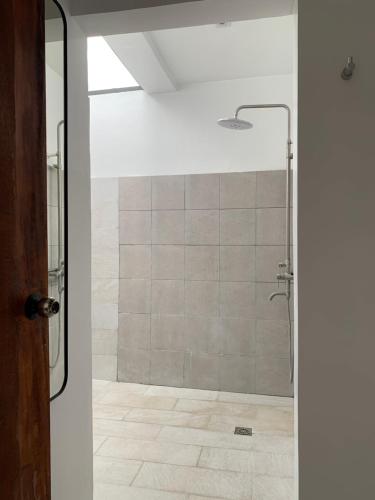 a shower with a glass door in a bathroom at Paradores Filipinas in Batangas City