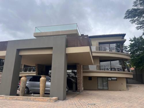 a house with a car parked in front of it at One O Eight Boutique Hotel in Benoni
