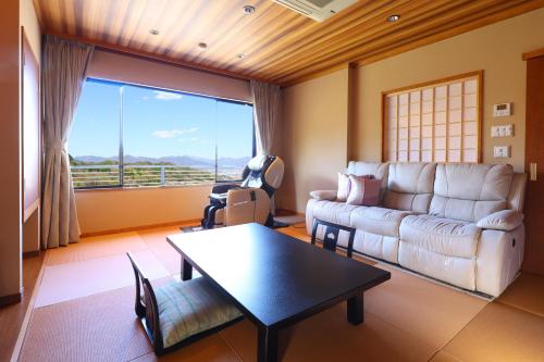 a living room with a couch and a table at 別所温泉 七草の湯 in Ueda