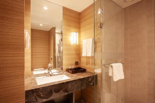 a bathroom with a sink and a shower at Crown Park Hotel Seoul Myeongdong in Seoul