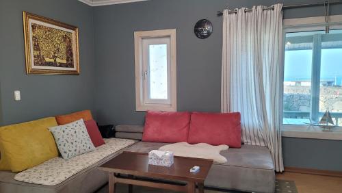 a living room with a couch and a table at Haumok52 Udo in Jeju