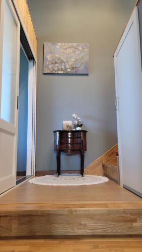 a small table in a room with an open door at Haumok52 Udo in Jeju
