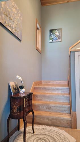 a room with a table and some stairs at Haumok52 Udo in Jeju