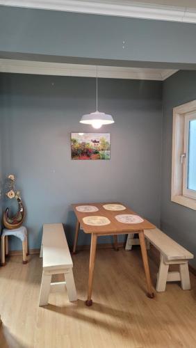 a dining room with a table and two benches at Haumok52 Udo in Jeju