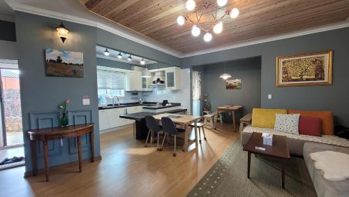 a living room and kitchen with a couch and a table at Haumok52 Udo in Jeju