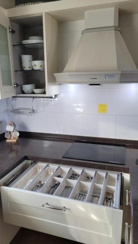 a kitchen with an open drawer in a kitchen at Haumok52 Udo in Jeju