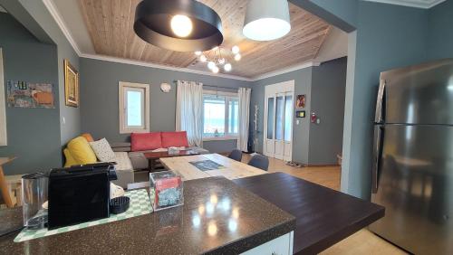 a kitchen and living room with a couch and a refrigerator at Haumok52 Udo in Jeju