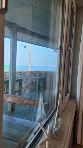 a window with a view of the ocean from a house at Haumok52 Udo in Jeju