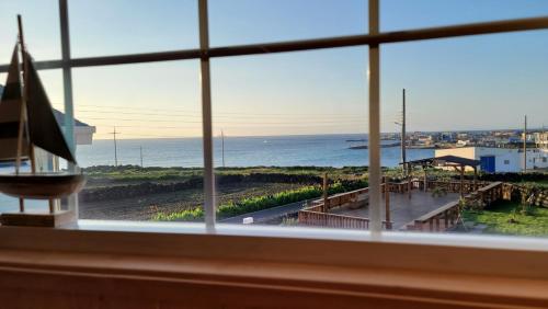 a view of the ocean from a window at Haumok52 Udo in Jeju