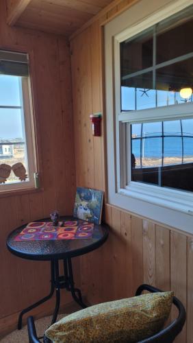 a small table in a room with a window at Haumok52 Udo in Jeju