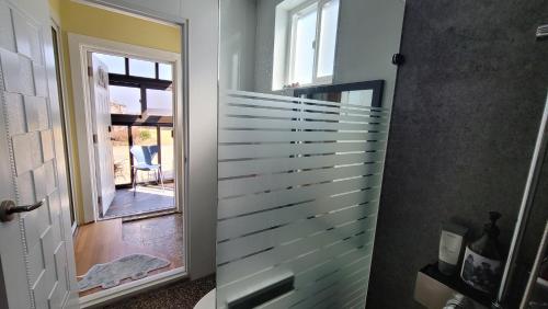 a hallway with a door to a room with a window at Haumok52 Udo in Jeju