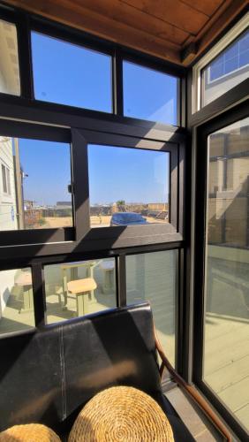a room with windows and a view of a patio at Haumok52 Udo in Jeju