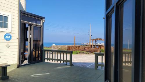 an open door of a building with a view of the ocean at Haumok52 Udo in Jeju