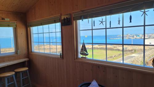 a room with windows with a view of the ocean at Haumok52 Udo in Jeju