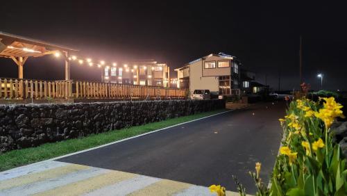 a street at night with a building with lights at Haumok52 Udo in Jeju