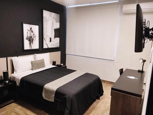 a bedroom with a bed and a television in it at Rua Hoteles Piura in Piura