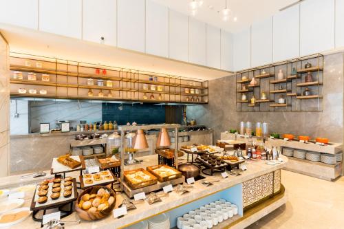 a bakery with a variety of pastries on display at Holiday Inn Lucknow Airport by IHG in Lucknow