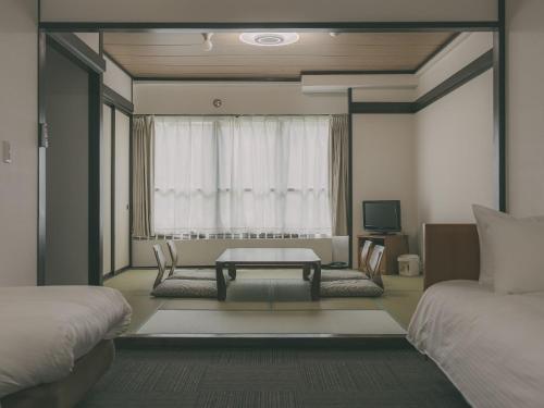 a living room with a couch and a table at Chalet Shiga in Yamanouchi