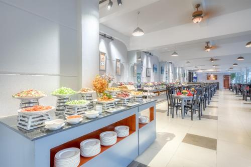 a buffet line in a restaurant with tables and chairs at Ocean Pearl Hotel Phu Quoc in Phu Quoc