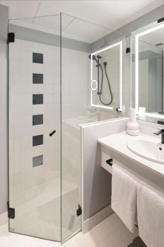 a bathroom with a shower and a sink at The Sebel Sydney Martin Place in Sydney
