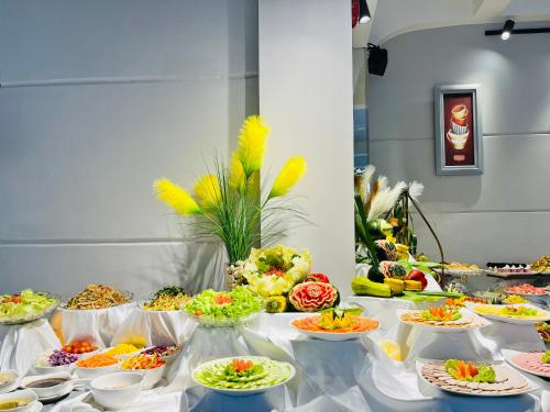 a table with many plates of food on it at Ocean Pearl Hotel Phu Quoc in Phu Quoc
