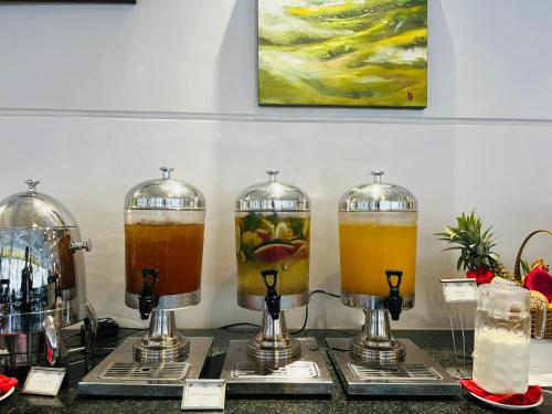 a display of drinks in glass jars on a counter at Ocean Pearl Hotel Phu Quoc in Phu Quoc
