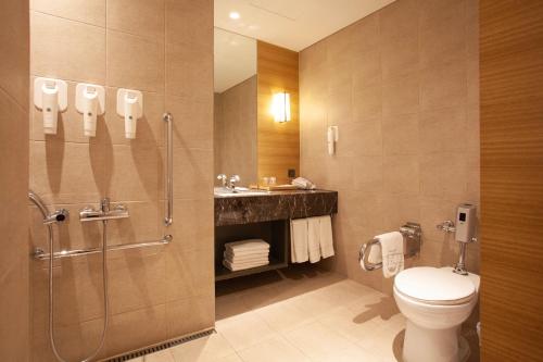 a bathroom with a shower and a toilet and a sink at Crown Park Hotel Seoul Myeongdong in Seoul